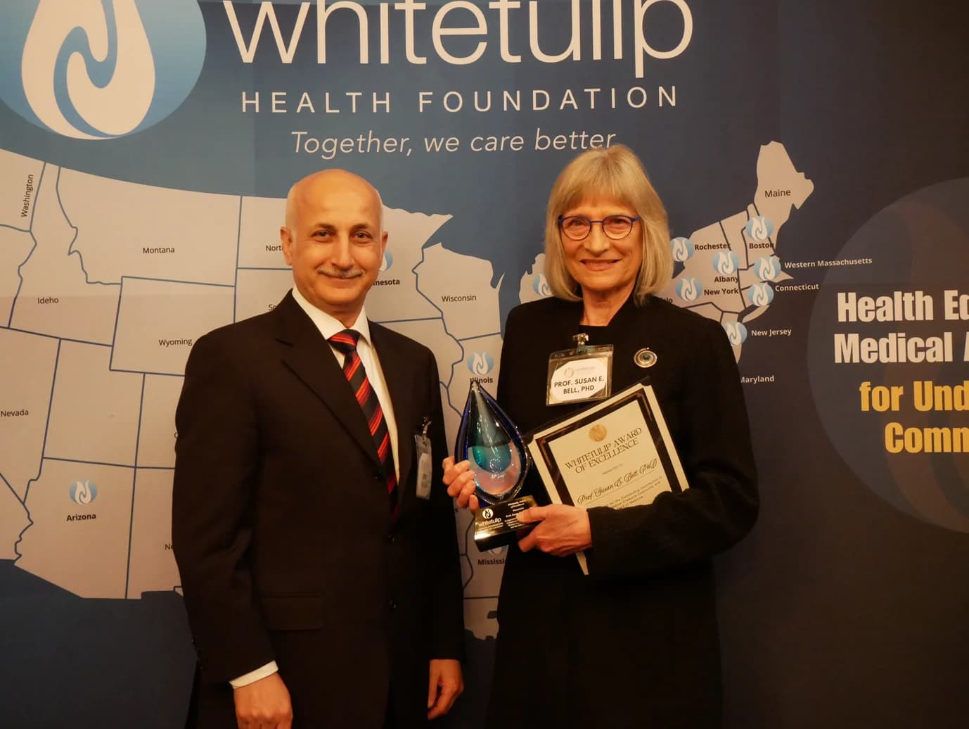 Susan E. Bell receiving the Whitetulip Award of Excellence